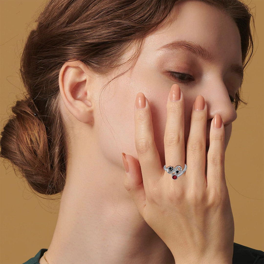 Adjustable Ring with Black Paw Print Design and Red Gemstone